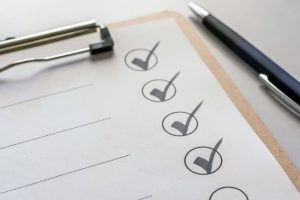 A clipboard with a checklist being checked off.